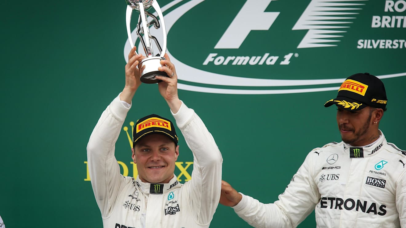 Race winner Lewis Hamilton (GBR) Mercedes AMG F1 celebrates with Valtteri Bottas (FIN) Mercedes AMG F1 on the podium with the trophy at Formula One World Championship, Rd10, British Grand Prix, Race, Silverstone, England, Sunday 16 July 2017. © Sutton Images