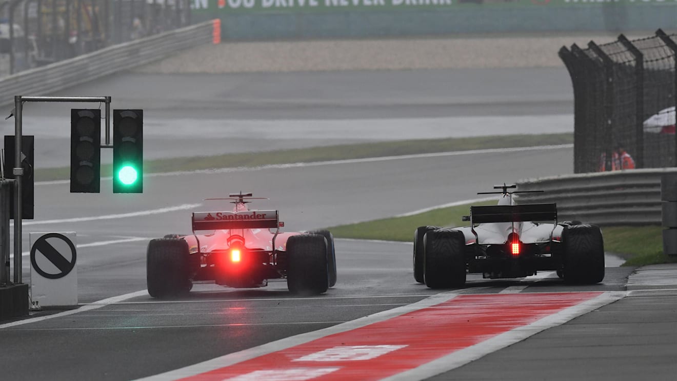 Sebastian Vettel (GER) Ferrari SF70-H and Romain Grosjean (FRA) Haas VF-17 at Formula One World Championship, Rd2, Chinese Grand Prix, Practice, Shanghai, China, Friday 7 April 2017. © Sutton Motorsport Images