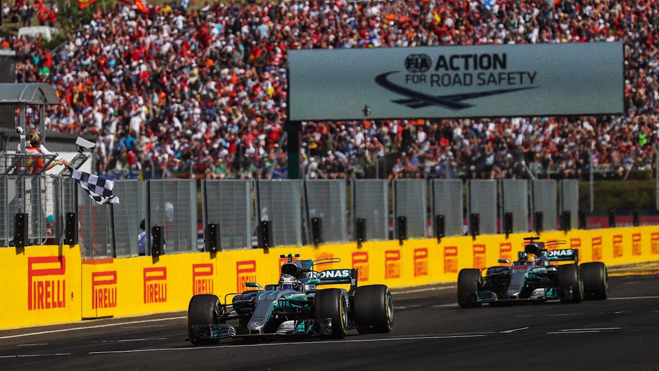 Valtteri Bottas (FIN) Mercedes-Benz F1 W08 Hybrid and Lewis Hamilton (GBR) Mercedes-Benz F1 W08 Hybrid cross the line to take the chequered flag and third and fourth positions respectively at Formula One World Championship, Rd11, Hungarian Grand Prix, Race, Hungaroring, Hungary, Sunday 30 July 2017. © Sutton Images