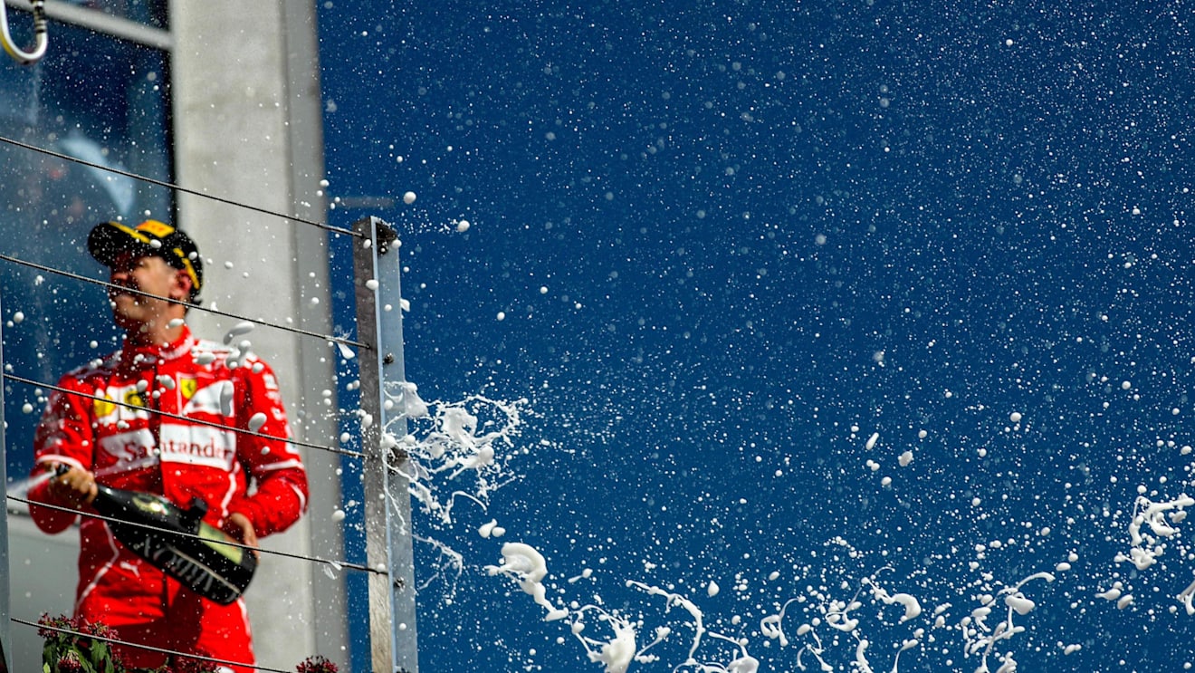 Race winner Sebastian Vettel (GER) Ferrari celebrates on the podium with the champagne at Formula One World Championship, Rd11, Hungarian Grand Prix, Race, Hungaroring, Hungary, Sunday 30 July 2017. © Sutton Images