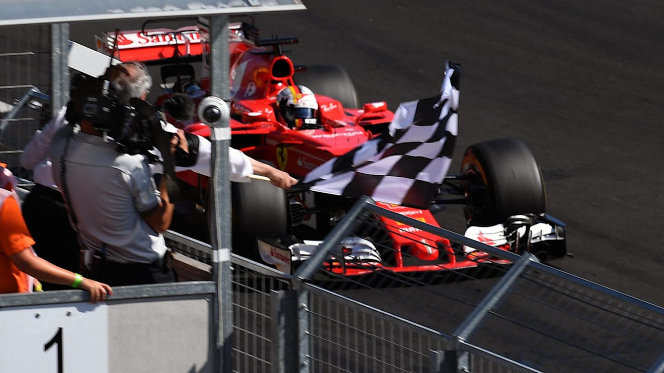 Race winner Sebastian Vettel (GER) Ferrari SF70-H takes the chequered flag at Formula One World Championship, Rd11, Hungarian Grand Prix, Race, Hungaroring, Hungary, Sunday 30 July 2017. © Sutton Images