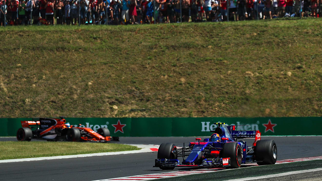 Carlos Sainz (ESP) Scuderia Toro Rosso STR12 leads Fernando Alonso (ESP) McLaren MCL32 at Formula One World Championship, Rd11, Hungarian Grand Prix, Race, Hungaroring, Hungary, Sunday 30 July 2017. © Sutton Images