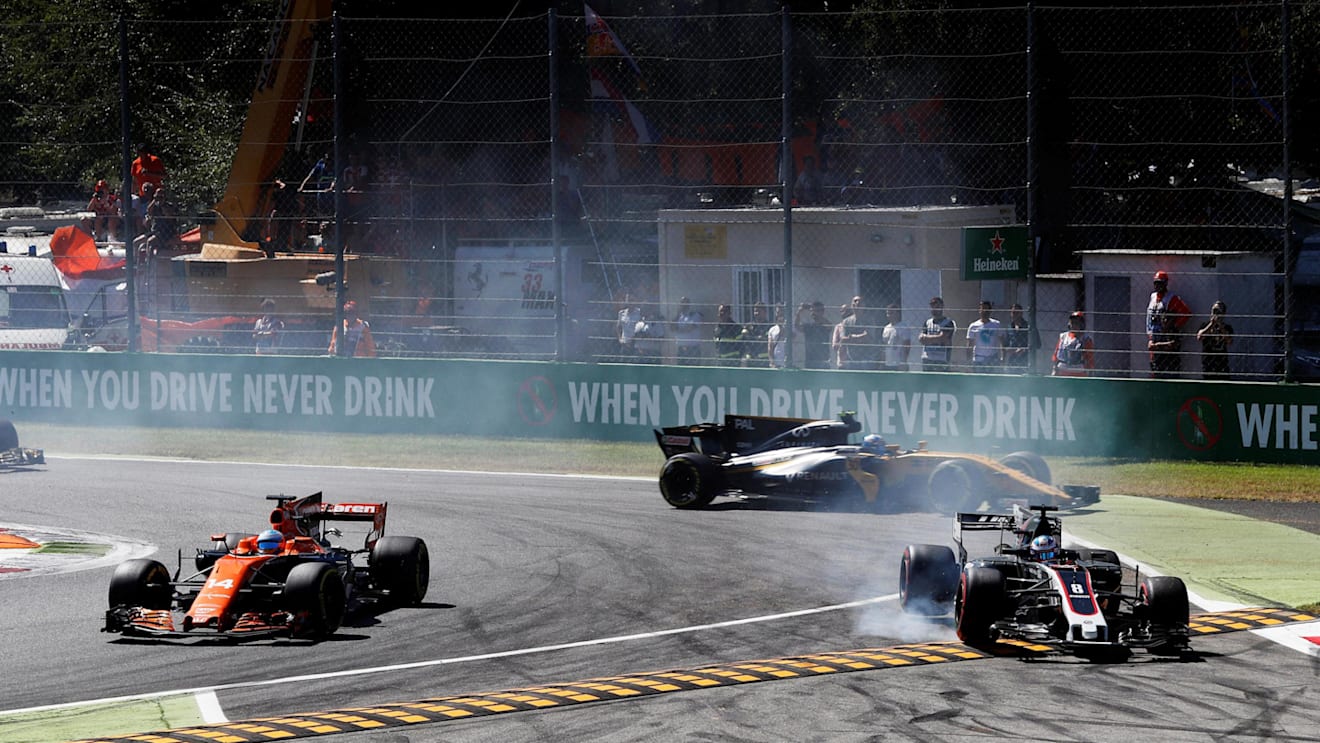 Fernando Alonso (ESP) McLaren MCL32, Romain Grosjean (FRA) Haas VF-17 and Jolyon Palmer (GBR) Renault Sport F1 Team RS17 battle at Formula One World Championship, Rd13, Italian Grand Prix, Race, Monza, Italy, Sunday 3 September 2017. © Sutton Images