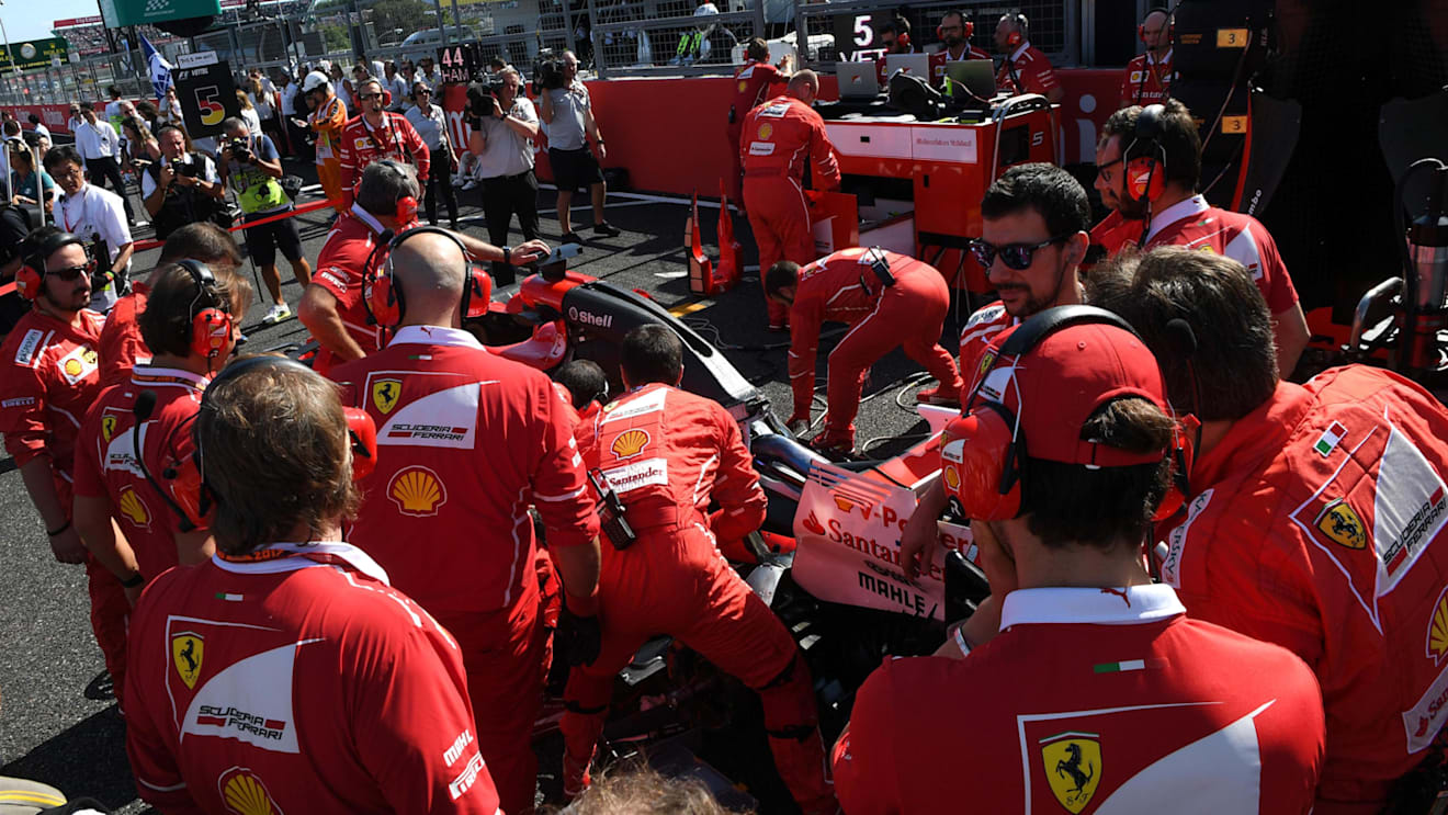 Ferrari mechanics observe the car of Sebastian Vettel (GER) Ferrari SF70-H on the grid with technical issues at Formula One World Championship, Rd16, Japanese Grand Prix, Race, Suzuka, Japan, Sunday 8 October 2017. © Mark Sutton/Sutton Images