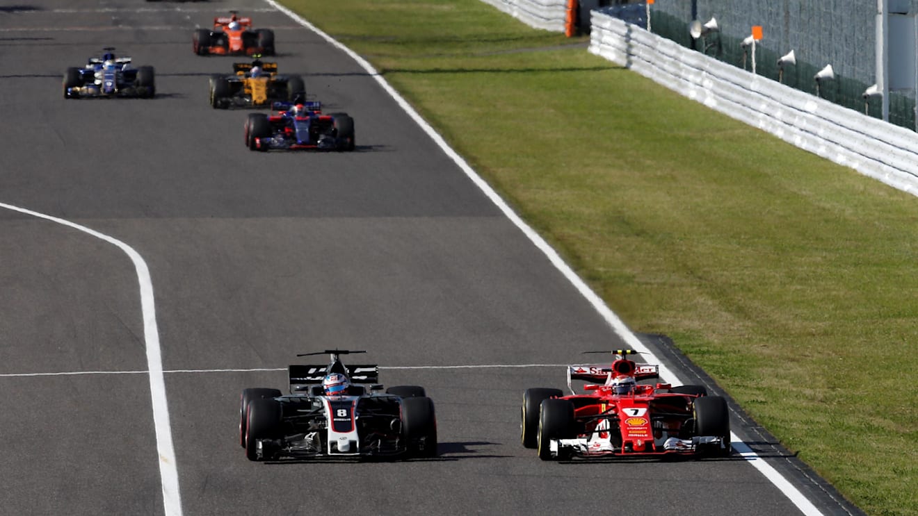 Romain Grosjean (FRA) Haas VF-17 and Kimi Raikkonen (FIN) Ferrari SF70-H battle for position at Formula One World Championship, Rd16, Japanese Grand Prix, Race, Suzuka, Japan, Sunday 8 October 2017. © Manuel Goria/Sutton Images