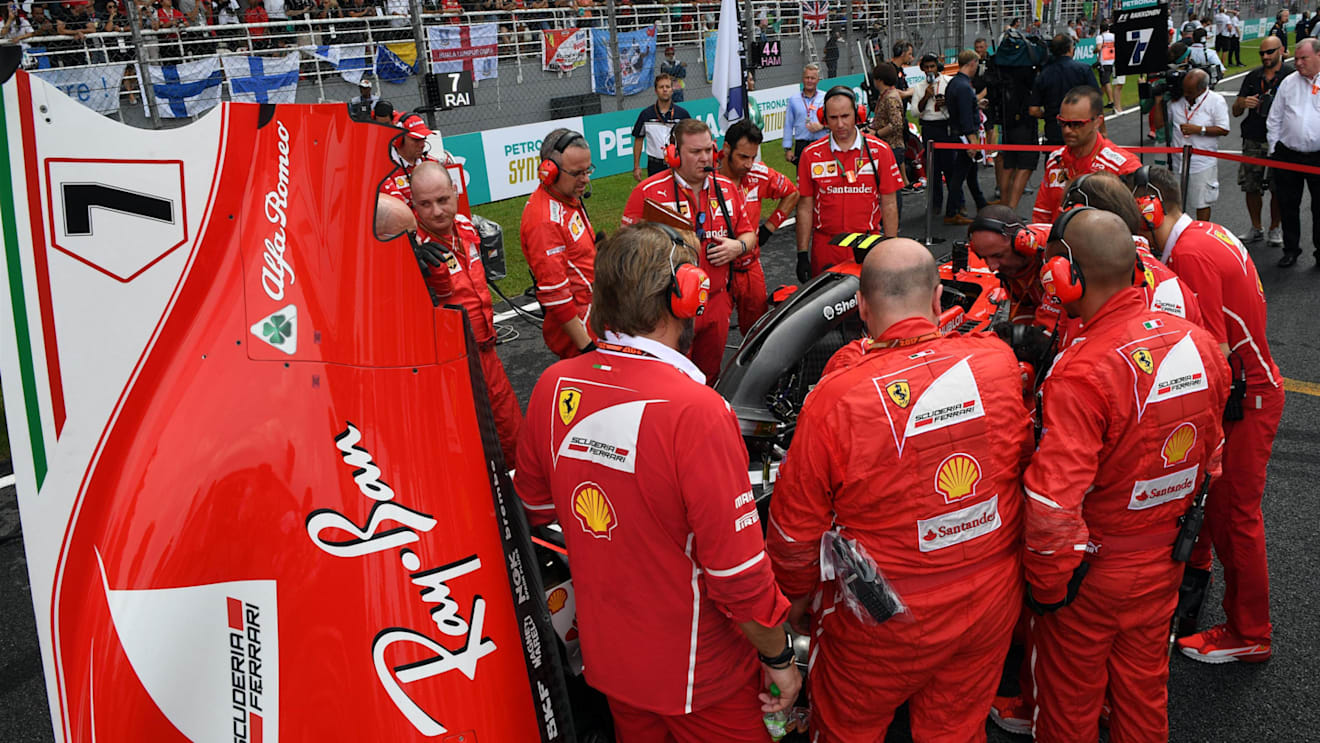 Ferrari mechanics observe the car of Kimi Raikkonen (FIN) Ferrari SF70-H with Turbo issues on the grid at Formula One World Championship, Rd15, Malaysian Grand Prix, Race, Sepang, Malaysia, Sunday 1 Octoberr 2017. © Mark Sutton/Sutton Images