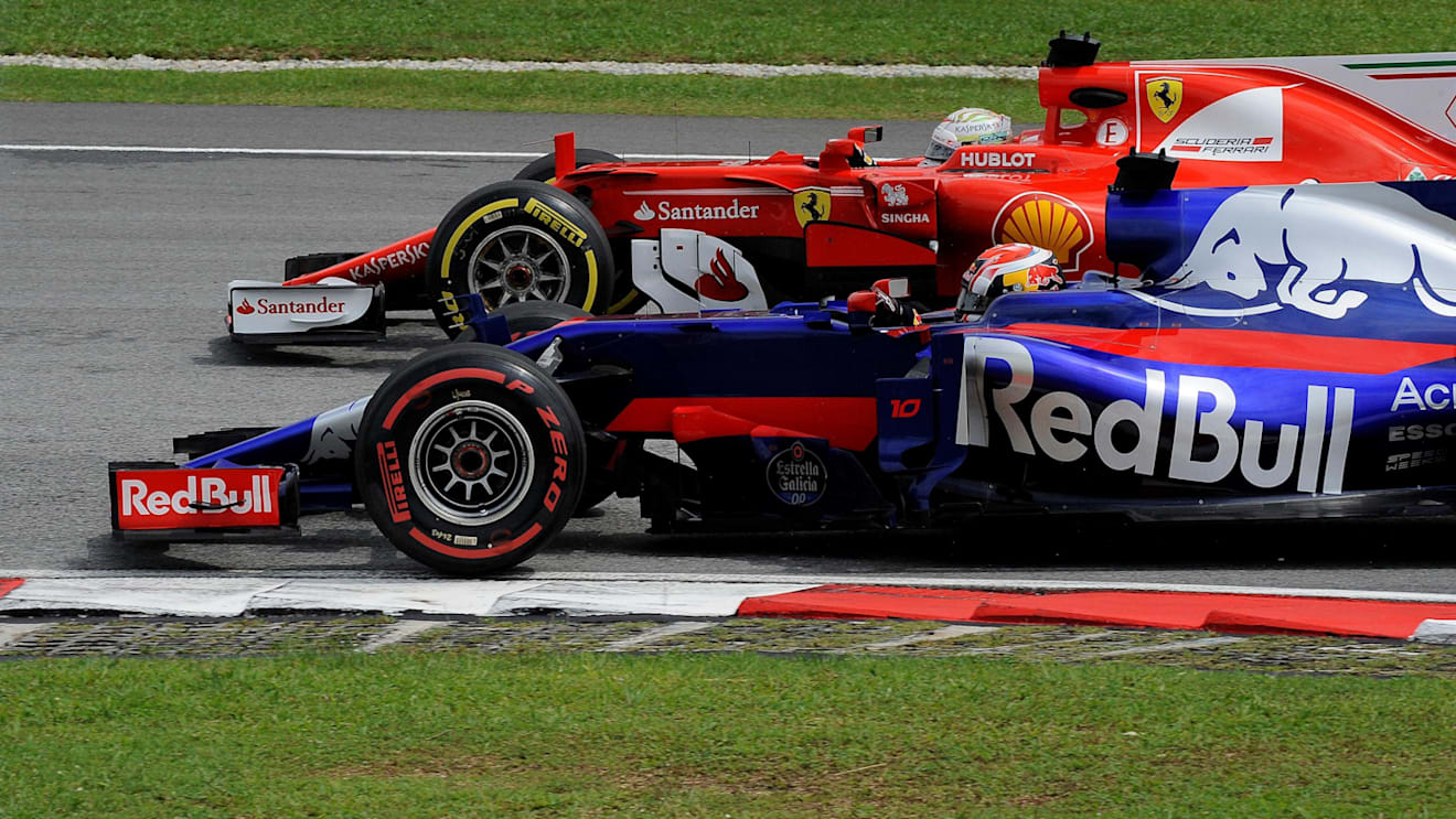 Pierre Gasly (FRA) Scuderia Toro Rosso STR12 battles with Sebastian Vettel (GER) Ferrari SF70-H at Formula One World Championship, Rd15, Malaysian Grand Prix, Race, Sepang, Malaysia, Sunday 1 October 2017. © Rubio/Sutton Images