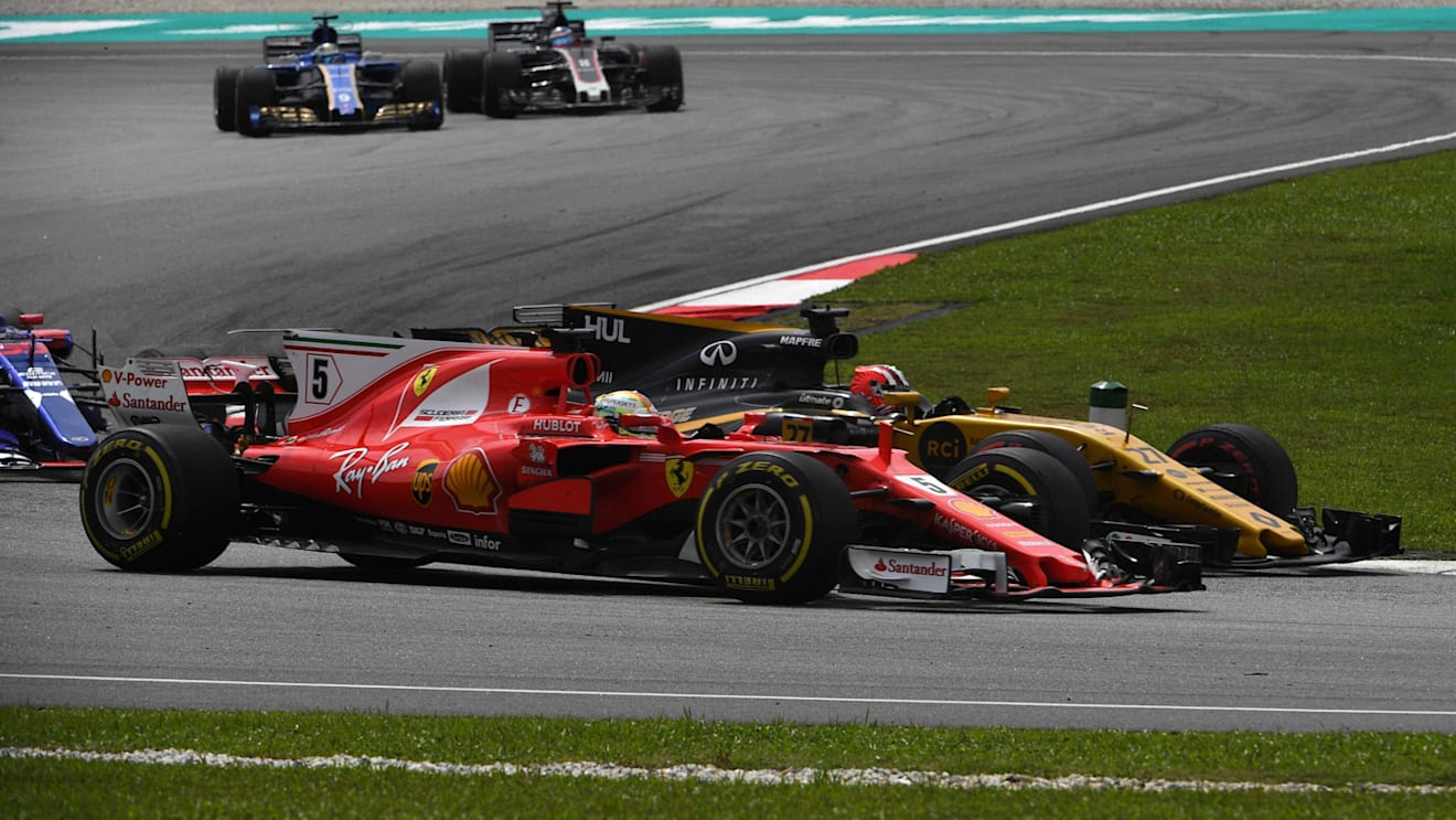 Sebastian Vettel (GER) Ferrari SF70-H and Nico Hulkenberg (GER) Renault Sport F1 Team RS17 battle at Formula One World Championship, Rd15, Malaysian Grand Prix, Race, Sepang, Malaysia, Sunday 1 October 2017. © Mark Sutton/Sutton Images