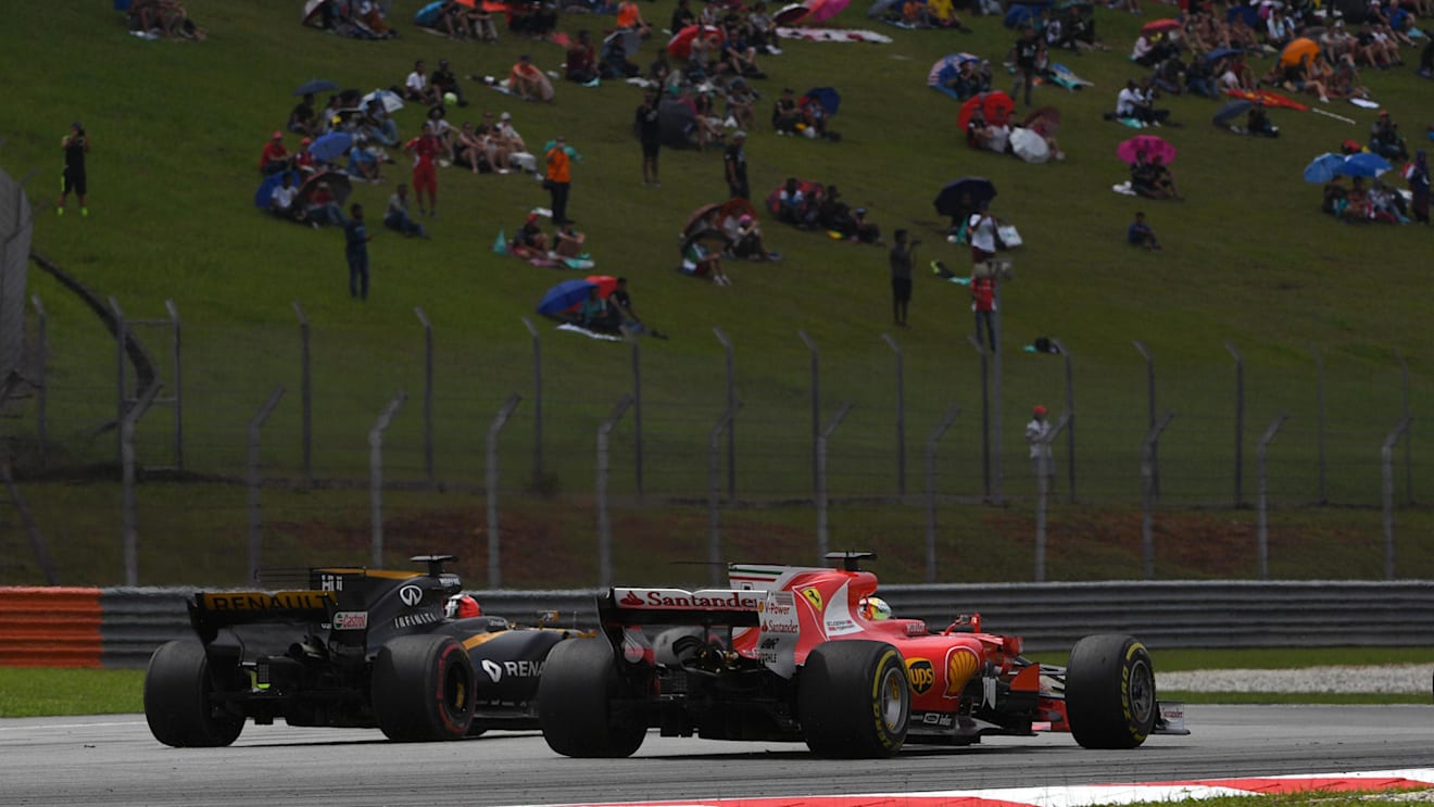 Sebastian Vettel (GER) Ferrari SF70-H and Nico Hulkenberg (GER) Renault Sport F1 Team RS17 battle at Formula One World Championship, Rd15, Malaysian Grand Prix, Race, Sepang, Malaysia, Sunday 1 October 2017. © Mark Sutton/Sutton Images