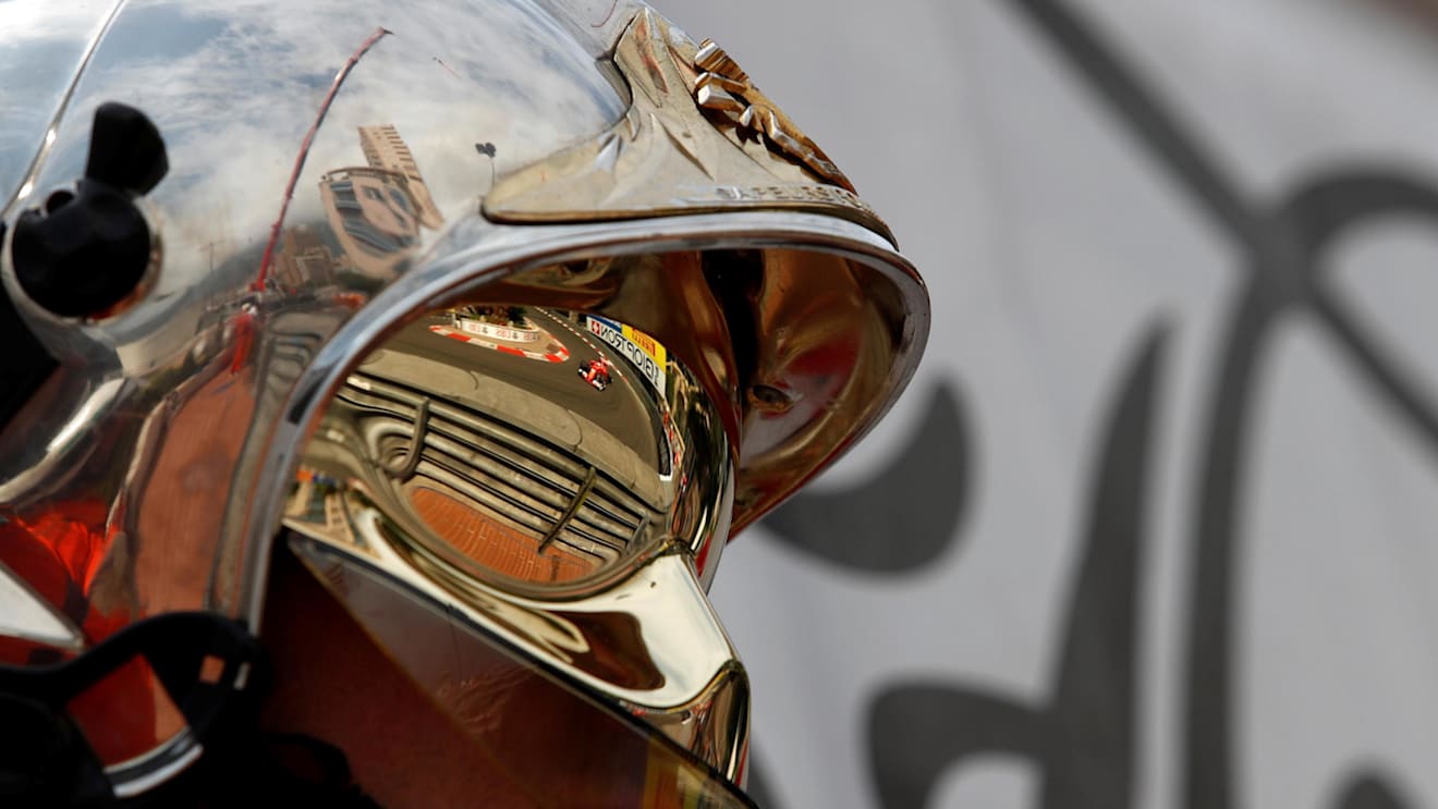Sebastian Vettel (GER) Ferrari SF70-H reflected in a fire marshals helmet at Formula One World Championship, Rd6, Monaco Grand Prix, Practice, Monte-Carlo, Monaco, Thursday 25 May 2017. © Sutton Images