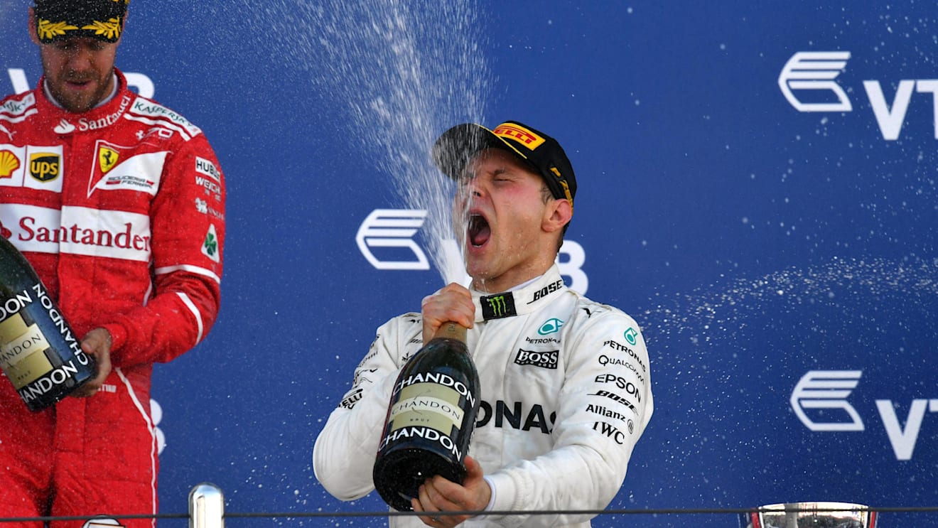 Vettel Ferrari and Race winner Bottas Mercedes celebrate on the podium with the champagne at Formula One World Championship, Rd4, Russian Grand Prix, Race, Sochi Autodrom, Sochi, Krasnodar Krai, Russia, Sunday 30 April 2017. © Sutton Motorsport Images
