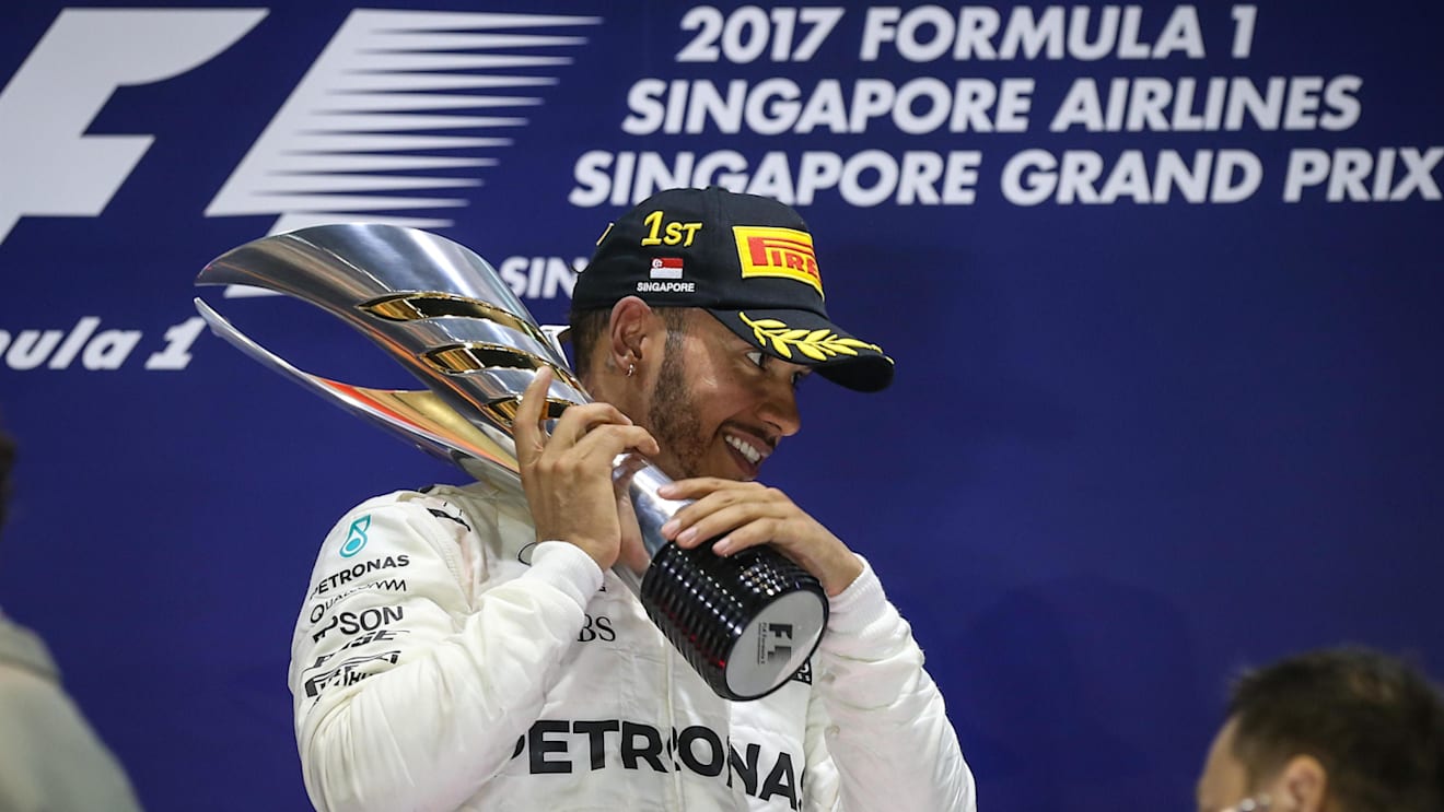 Race winner Lewis Hamilton (GBR) Mercedes AMG F1 celebrates on the podium with the trophy at Formula One World Championship, Rd14, Singapore Grand Prix, Race, Marina Bay Street Circuit, Singapore, Sunday 17 September 2017. © Mirko Stange/Sutton Images