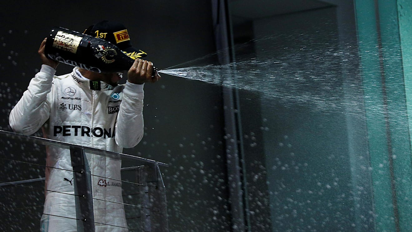 Race winner Lewis Hamilton (GBR) Mercedes AMG F1 celebrates on the podium with the champagne at Formula One World Championship, Rd14, Singapore Grand Prix, Race, Marina Bay Street Circuit, Singapore, Sunday 17 September 2017. © Kym Illman/Sutton Images