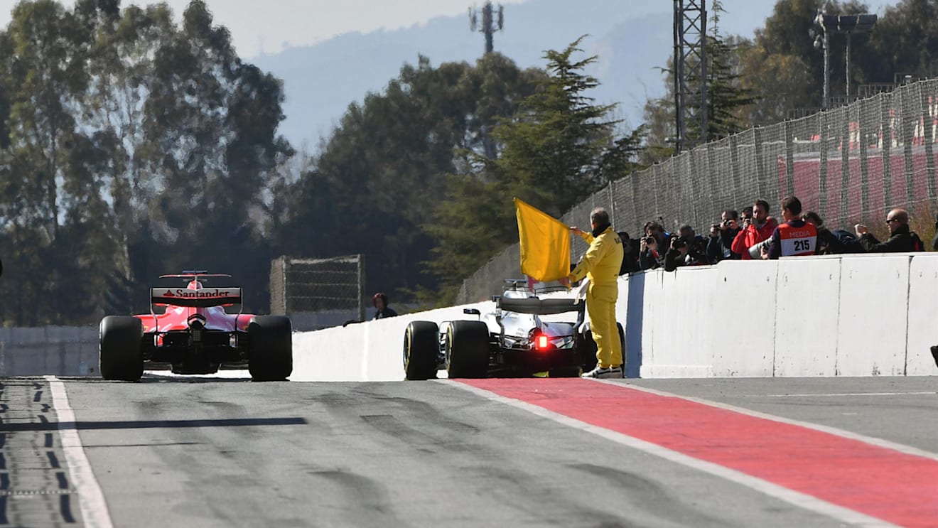 Sebastian Vettel (GER) Ferrari SF70-H, Valtteri Bottas (FIN) Mercedes-Benz F1 W08 Hybrid and marshal with yellow flag at Formula One Testing, Day Three, Barcelona, Spain, 1 March 2017. © Sutton Images