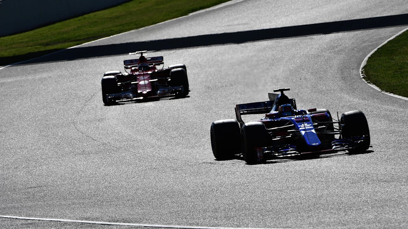 Carlos Sainz jr (ESP) Scuderia Toro Rosso STR12 and Kimi Raikkonen (FIN) Ferrari SF70-H at Formula One Testing, Day Four, Barcelona, Spain, 10 March 2017. © Sutton Images