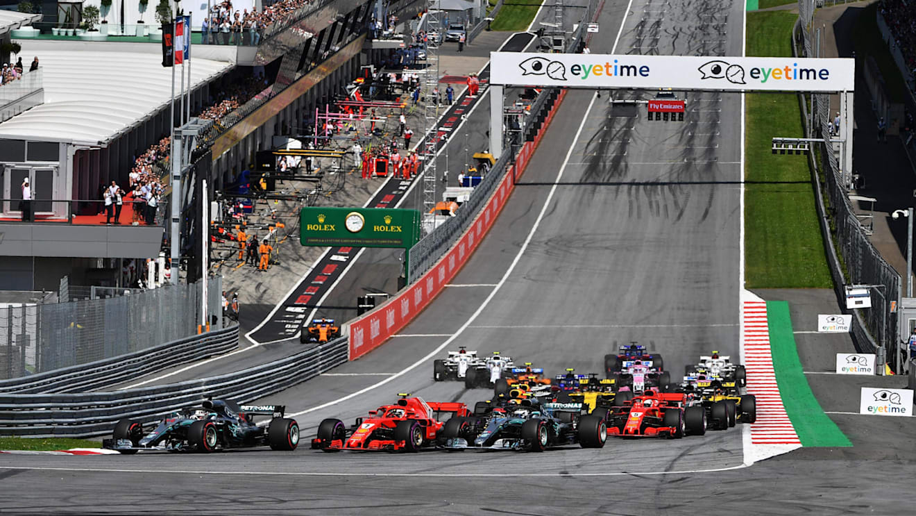 Lewis Hamilton (GBR) Mercedes-AMG F1 W09 EQ Power+, Valtteri Bottas (FIN) Mercedes-AMG F1 W09 EQ Power+ and Kimi Raikkonen (FIN) Ferrari SF-71H battle at the start of the race at Formula One World Championship, Rd9, Austrian Grand Prix, Race, Spielberg, Austria, Sunday 1 July 2018. © Mark Sutton/Sutton Images