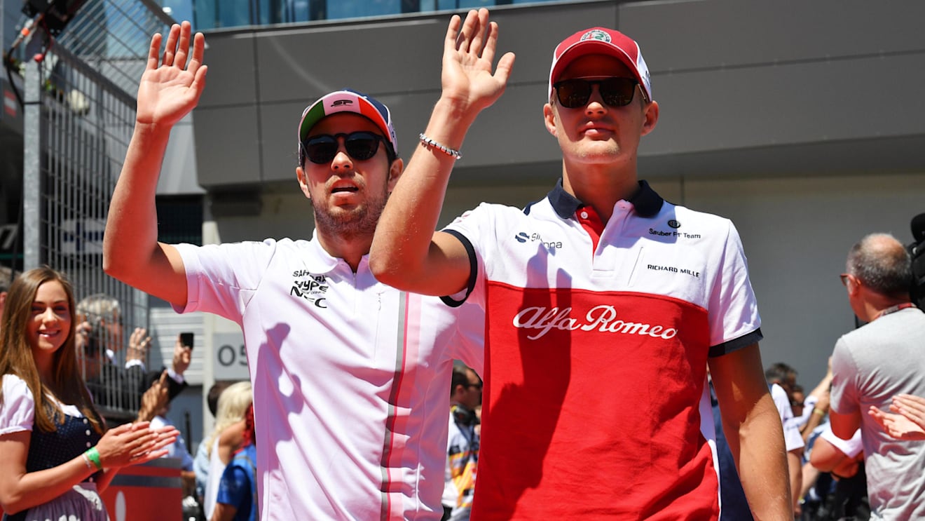 Sergio Perez (MEX) Force India and Marcus Ericsson (SWE) Alfa Romeo Sauber F1 Team on the drivers parade at Formula One World Championship, Rd9, Austrian Grand Prix, Race, Spielberg, Austria, Sunday 1 July 2018. © Mark Sutton/Sutton Images