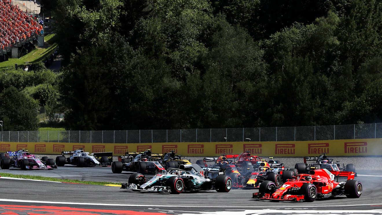 Lewis Hamilton (GBR) Mercedes-AMG F1 W09 EQ Power+ and Kimi Raikkonen (FIN) Ferrari SF-71H battle on lap one at Formula One World Championship, Rd9, Austrian Grand Prix, Race, Spielberg, Austria, Sunday 1 July 2018. © Manuel Goria/Sutton Images