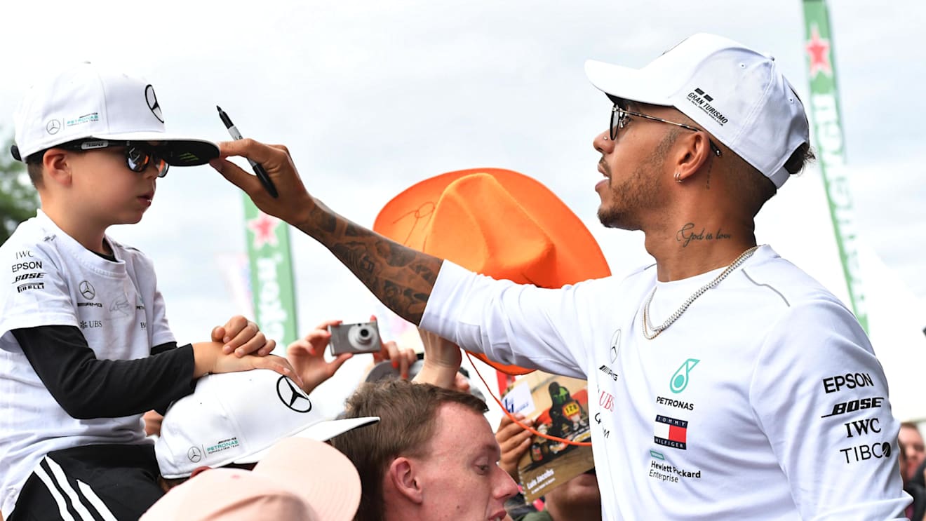 Lewis Hamilton (GBR) Mercedes-AMG F1 and young fan at Formula One World Championship, Rd9, Austrian Grand Prix, Preparations, Spielberg, Austria, Thursday 28 June 2018. © Jerry Andre/Sutton Images