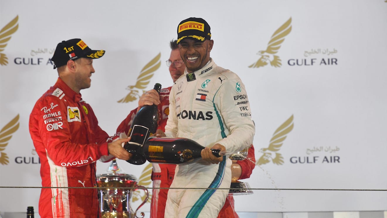 Sebastian Vettel (GER) Ferrari and Lewis Hamilton (GBR) Mercedes-AMG F1 celebrate on the podium at Formula One World Championship, Rd2, Bahrain Grand Prix, Race, Bahrain International Circuit, Sakhir, Bahrain, Sunday 8 April 2018.©Mark Sutton/Sutton Images