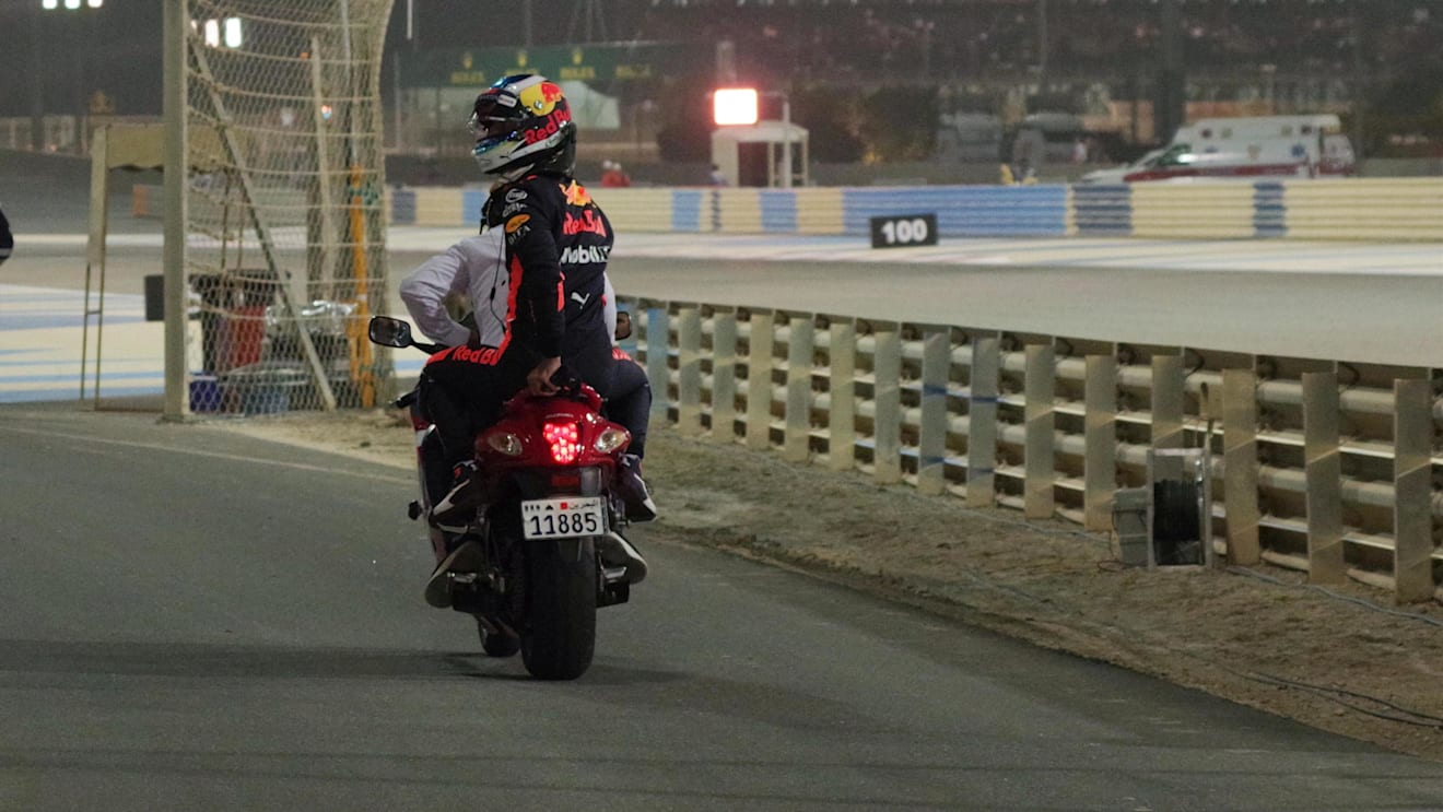 Race Retiree Daniel Ricciardo (AUS) Red Bull Racing gets a lift back to the pits on a motorbike at Formula One World Championship, Rd2, Bahrain Grand Prix, Race, Bahrain International Circuit, Sakhir, Bahrain, Sunday 8 April 2018. © Michael Memmler/Sutton