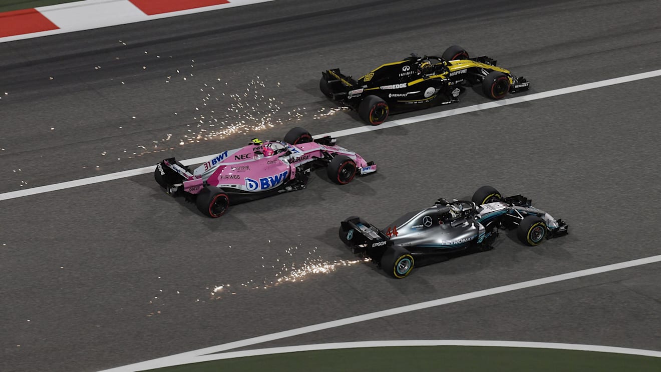 Lewis Hamilton (GBR) Mercedes-AMG F1 W09 EQ Power+, Esteban Ocon (FRA) Force India VJM11 and Nico Hulkenberg (GER) Renault Sport F1 Team RS18 bttle and sparks at Formula One World Championship, Rd2, Bahrain Grand Prix, Race, Bahrain International Circuit, Sakhir, Bahrain, Sunday 8 April 2018. © Mark Sutton/Sutton Images