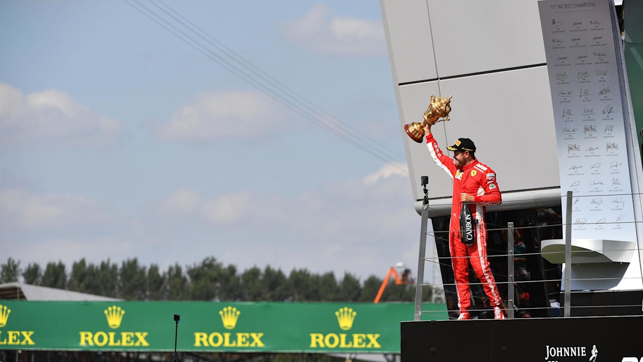 Race winner Sebastian Vettel (GER) Ferrari celebrates on the podium with the trophy at Formula One World Championship, Rd10, British Grand Prix, Race, Silverstone, England, Sunday 8 July 2018. © Mark Sutton/Sutton Images