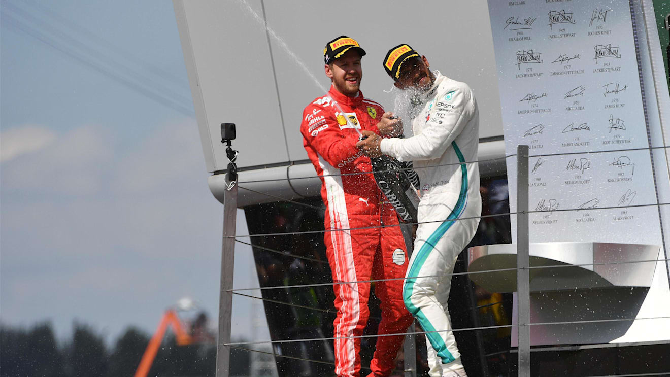 Sebastian Vettel (GER) Ferrari and Lewis Hamilton (GBR) Mercedes-AMG F1 celebrates on the podium with the champagne at Formula One World Championship, Rd10, British Grand Prix, Race, Silverstone, England, Sunday 8 July 2018. © Mark Sutton/Sutton Images