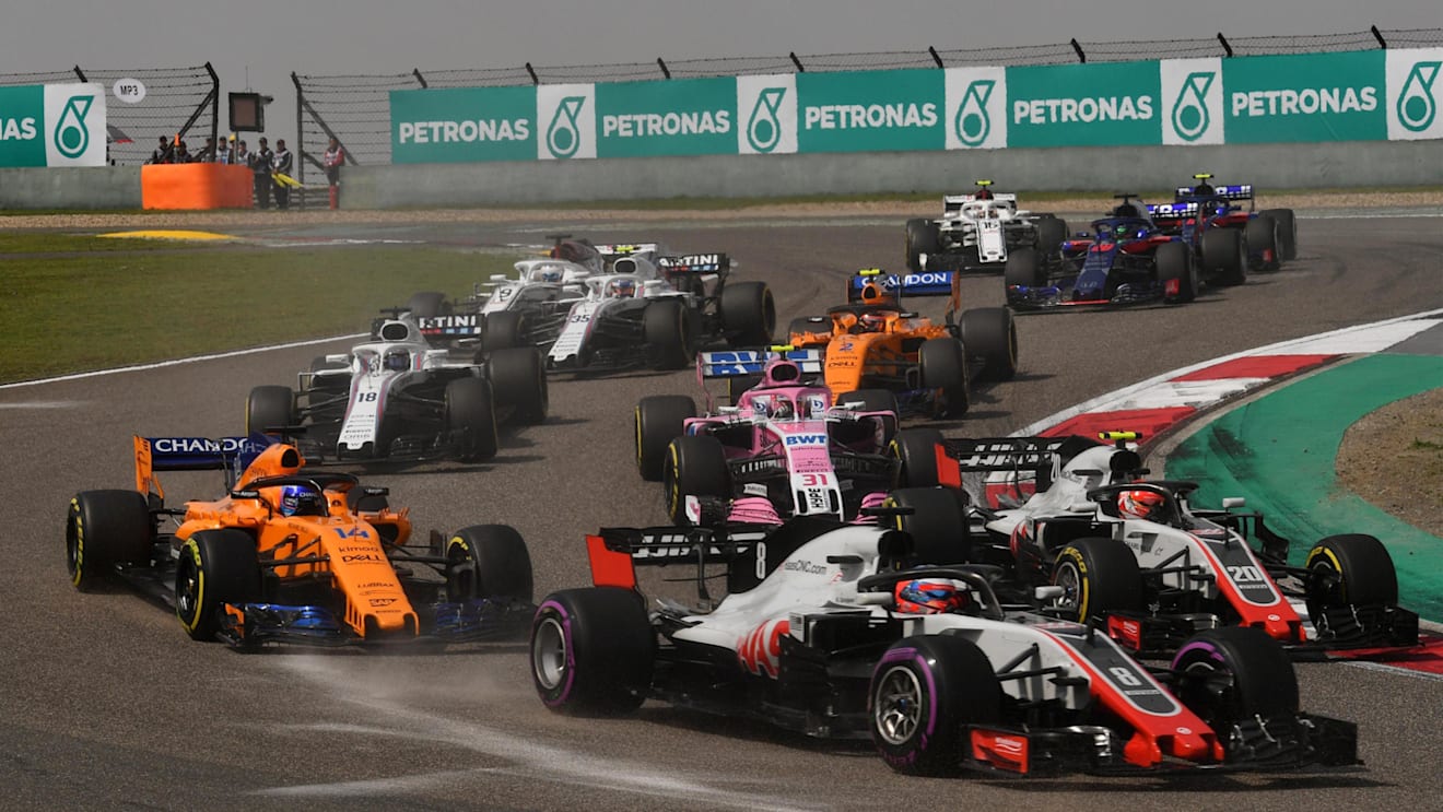 Romain Grosjean (FRA) Haas VF-18 and Fernando Alonso (ESP) McLaren MCL33 at the start of the race at Formula One World Championship, Rd3, Chinese Grand Prix, Race, Shanghai, China, Sunday 15 April 2018. © Mark Sutton/Sutton Images