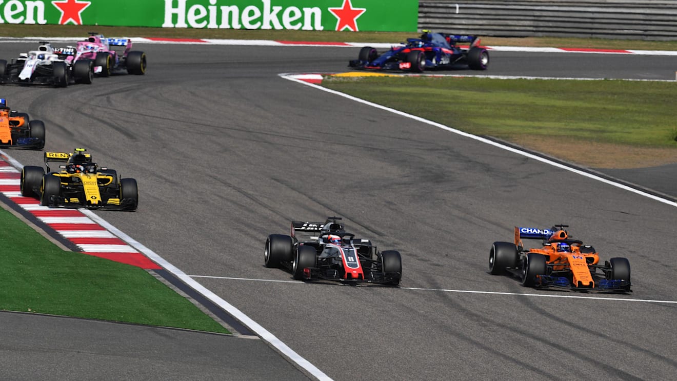 Romain Grosjean (FRA) Haas VF-18 and Fernando Alonso (ESP) McLaren MCL33 battle at Formula One World Championship, Rd3, Chinese Grand Prix, Race, Shanghai, China, Sunday 15 April 2018. © Mark Sutton/Sutton Images
