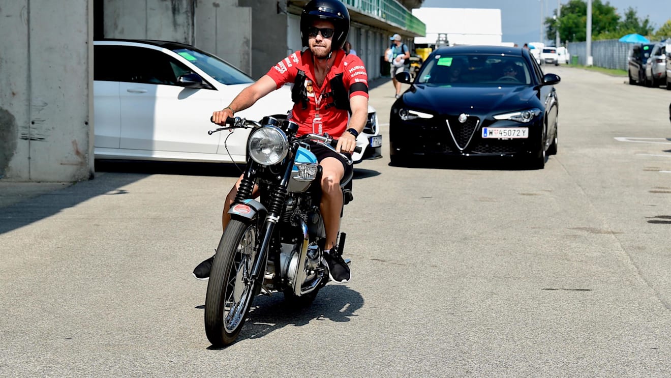 Sebastian Vettel (GER) Ferrari on his Triumph motorbike at Formula One World Championship, Rd12, Hungarian Grand Prix, Qualifying, Hungaroring, Hungary, Saturday 28 July 2018. © Jerry Andre/Sutton Images