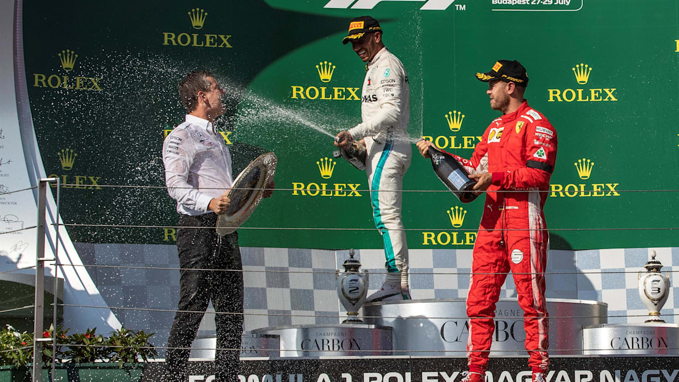 Lewis Hamilton (GBR) Mercedes-AMG F1 and Sebastian Vettel (GER) Ferrari celebrate on the podium with the champagne at Formula One World Championship, Rd12, Hungarian Grand Prix, Race, Hungaroring, Hungary, Sunday 29 July 2018. © Manuel Goria/Sutton Images
