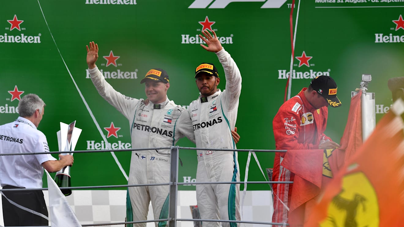 Race winner Lewis Hamilton, Mercedes AMG F1 celebrates on the podium with Valtteri Bottas, Mercedes AMG F1 as Kimi Raikkonen, Ferrari signs a flag at Formula One World Championship, Rd14, Italian Grand Prix, Race, Monza, Italy, Sunday 2 September 2018. © Mark Sutton/Sutton Images