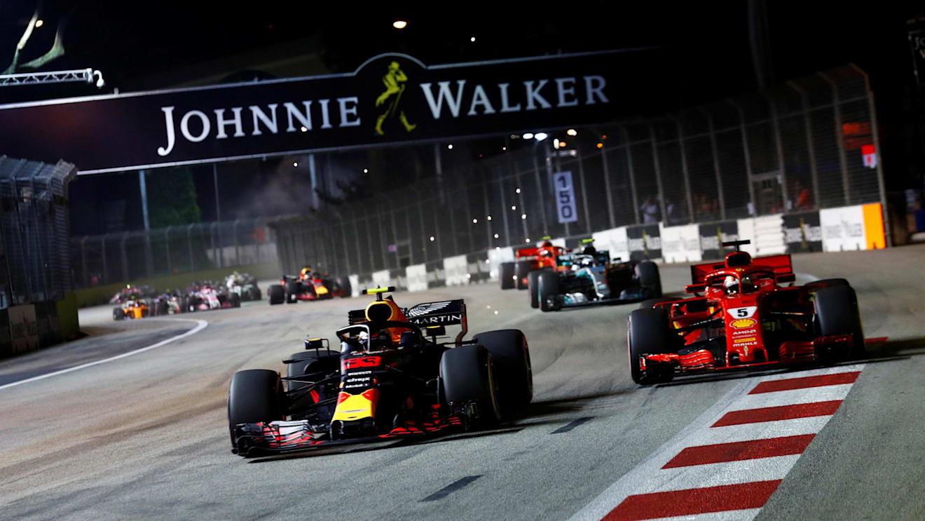 Max Verstappen, Red Bull Racing RB14 and Sebastian Vettel, Ferrari SF71H battle on lap one at Formula One World Championship, Rd15, Singapore Grand Prix, Race, Marina Bay Circuit, Singapore, Sunday 16 September 2018.