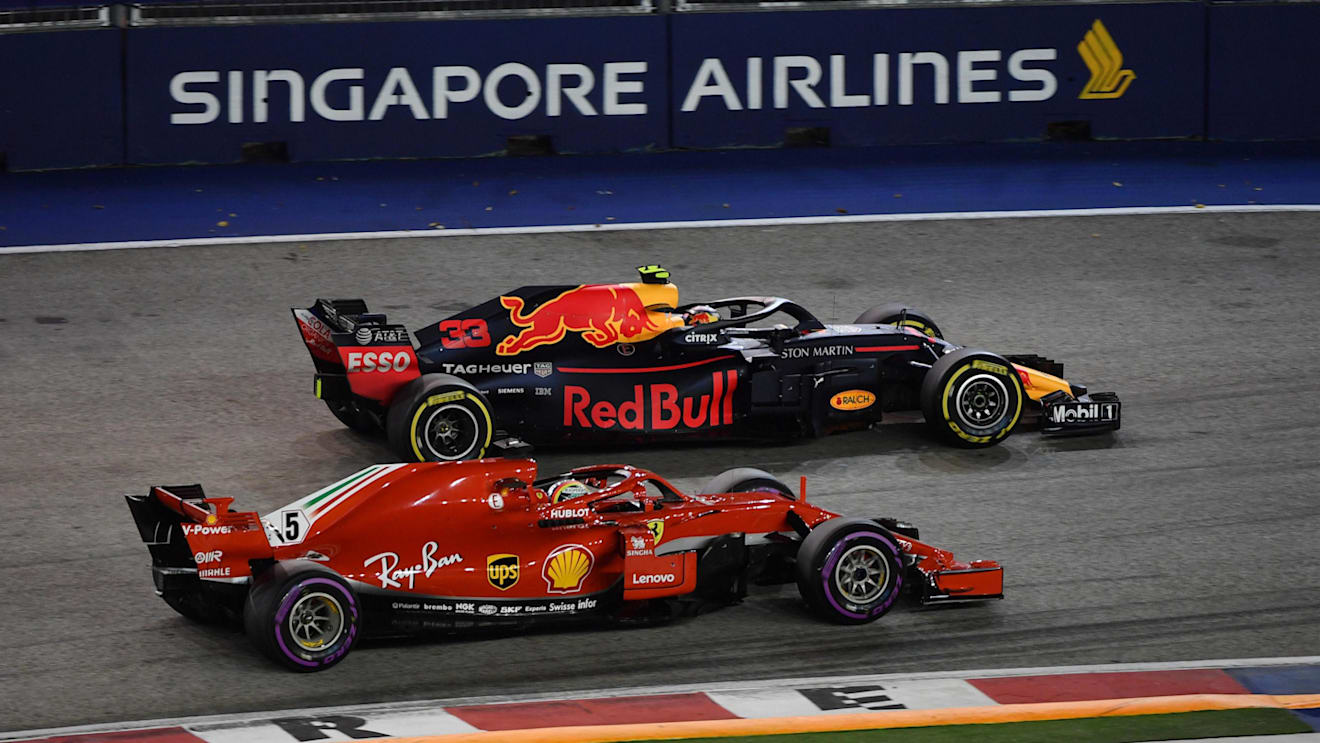 Sebastian Vettel, Ferrari SF71H and Max Verstappen, Red Bull Racing RB14 battle at Formula One World Championship, Rd15, Singapore Grand Prix, Race, Marina Bay Circuit, Singapore, Sunday 16 September 2018.