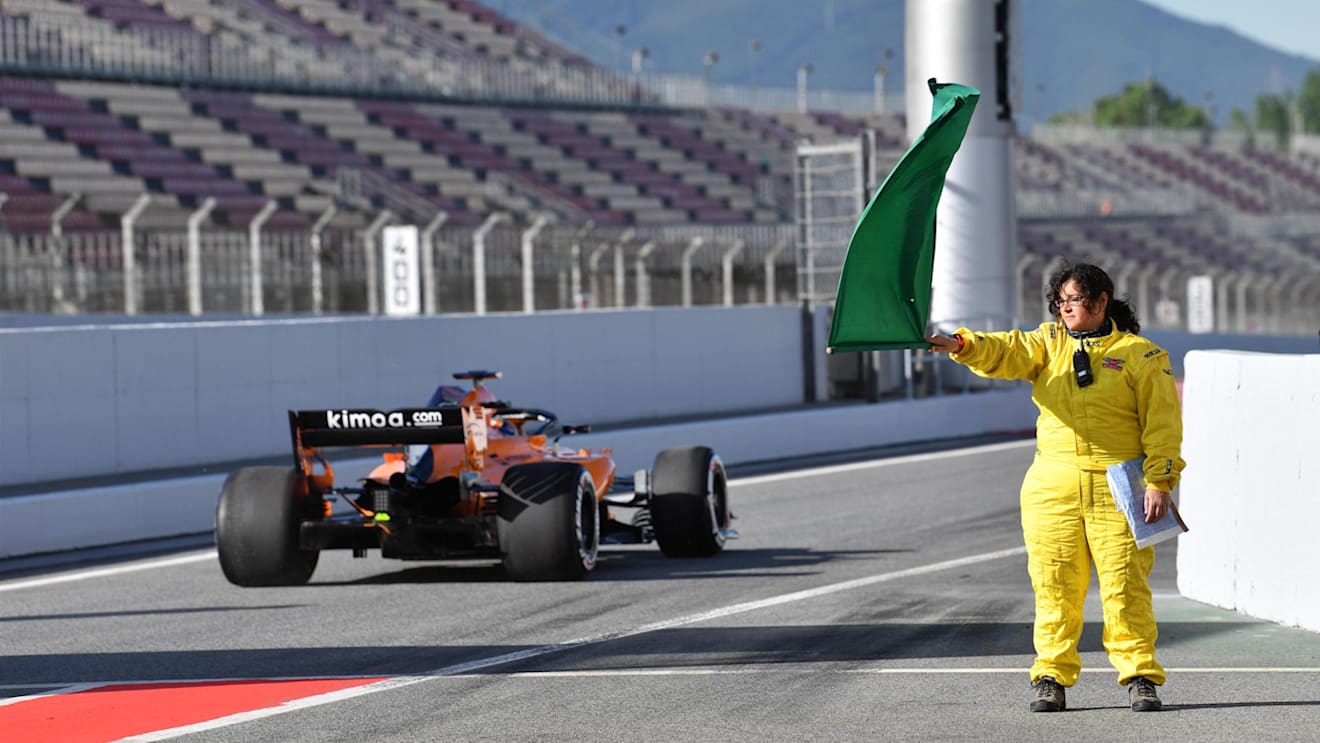 Marshals waces the green flag at Formula One Testing, Day One, Barcelona, Spain, Tuesday 15 May 2018. © Mark Sutton/Sutton Images
