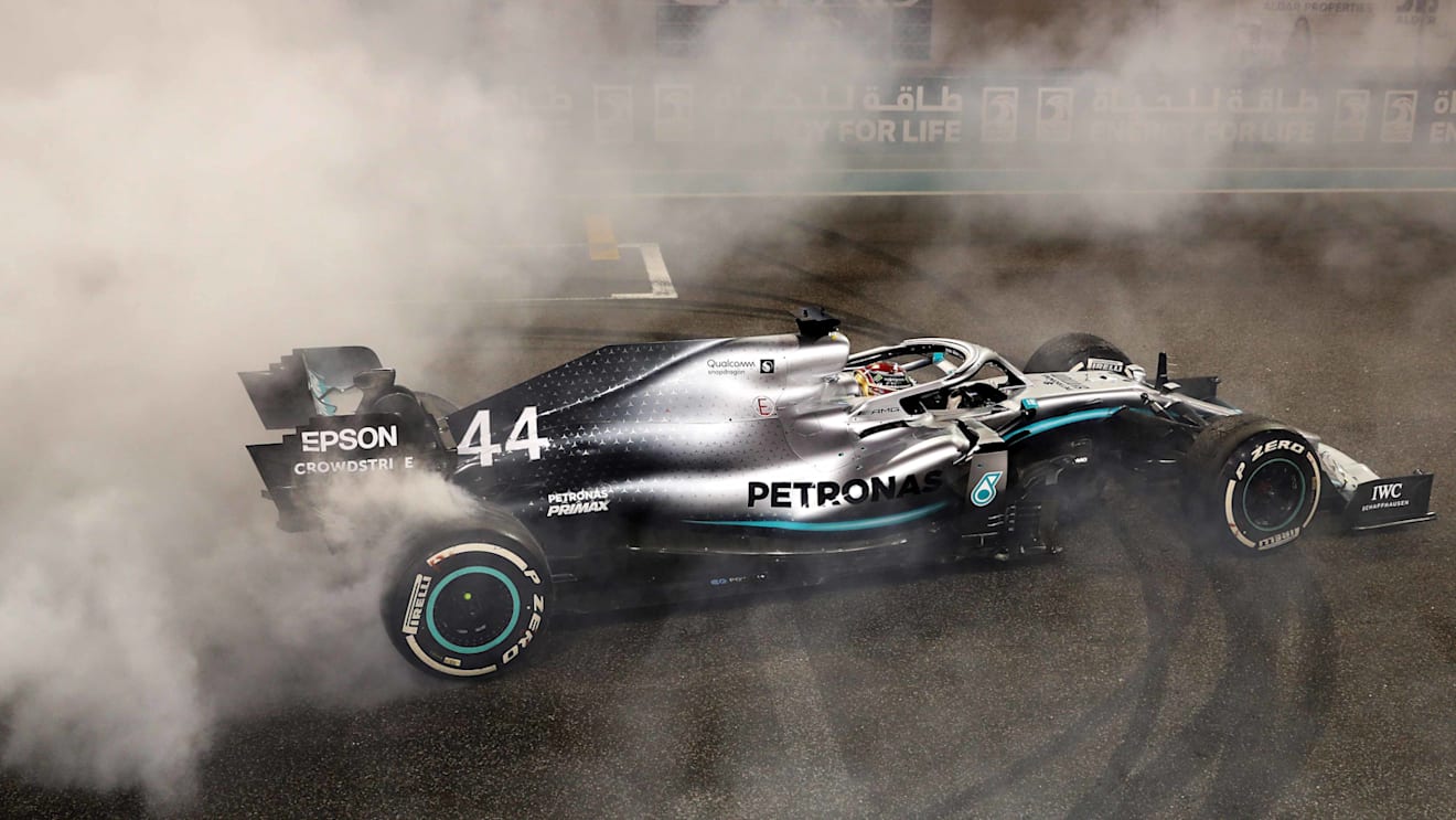 ABU DHABI, UNITED ARAB EMIRATES - DECEMBER 01: Race winner Lewis Hamilton of Great Britain and Mercedes GP celebrates with donuts on track during the F1 Grand Prix of Abu Dhabi at Yas Marina Circuit on December 01, 2019 in Abu Dhabi, United Arab Emirates. (Photo by Mark Thompson/Getty Images)