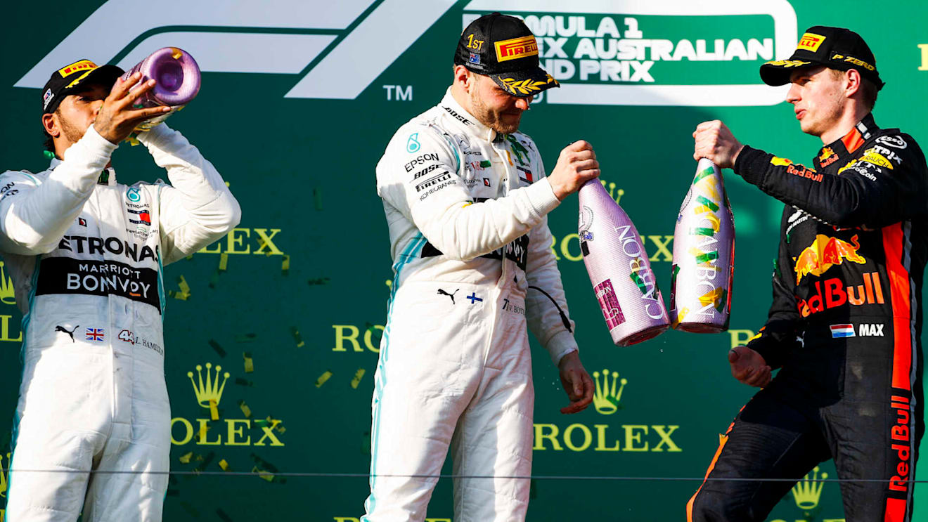 MELBOURNE GRAND PRIX CIRCUIT, AUSTRALIA - MARCH 17: Lewis Hamilton, Mercedes AMG F1, 2nd position, Valtteri Bottas, Mercedes AMG F1, 1st position, and Max Verstappen, Red Bull Racing, 3rd position, celebrate with Champagne on the podium during the Australian GP at Melbourne Grand Prix Circuit on March 17, 2019 in Melbourne Grand Prix Circuit, Australia. (Photo by Glenn Dunbar / LAT Images)