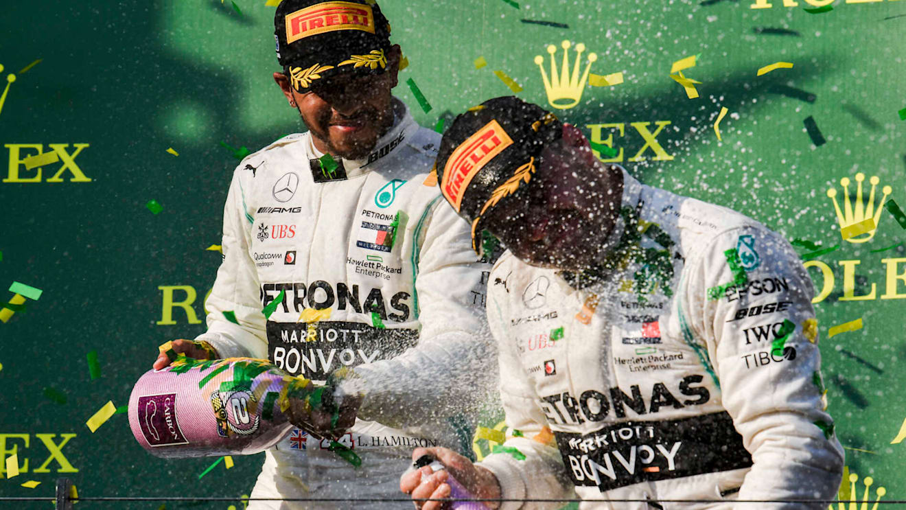 MELBOURNE GRAND PRIX CIRCUIT, AUSTRALIA - MARCH 17: Lewis Hamilton, Mercedes AMG F1, 2nd position, sprays Valtteri Bottas, Mercedes AMG F1, 1st position, with Champagne on the podium during the Australian GP at Melbourne Grand Prix Circuit on March 17, 2019 in Melbourne Grand Prix Circuit, Australia. (Photo by Mark Sutton / Sutton Images)