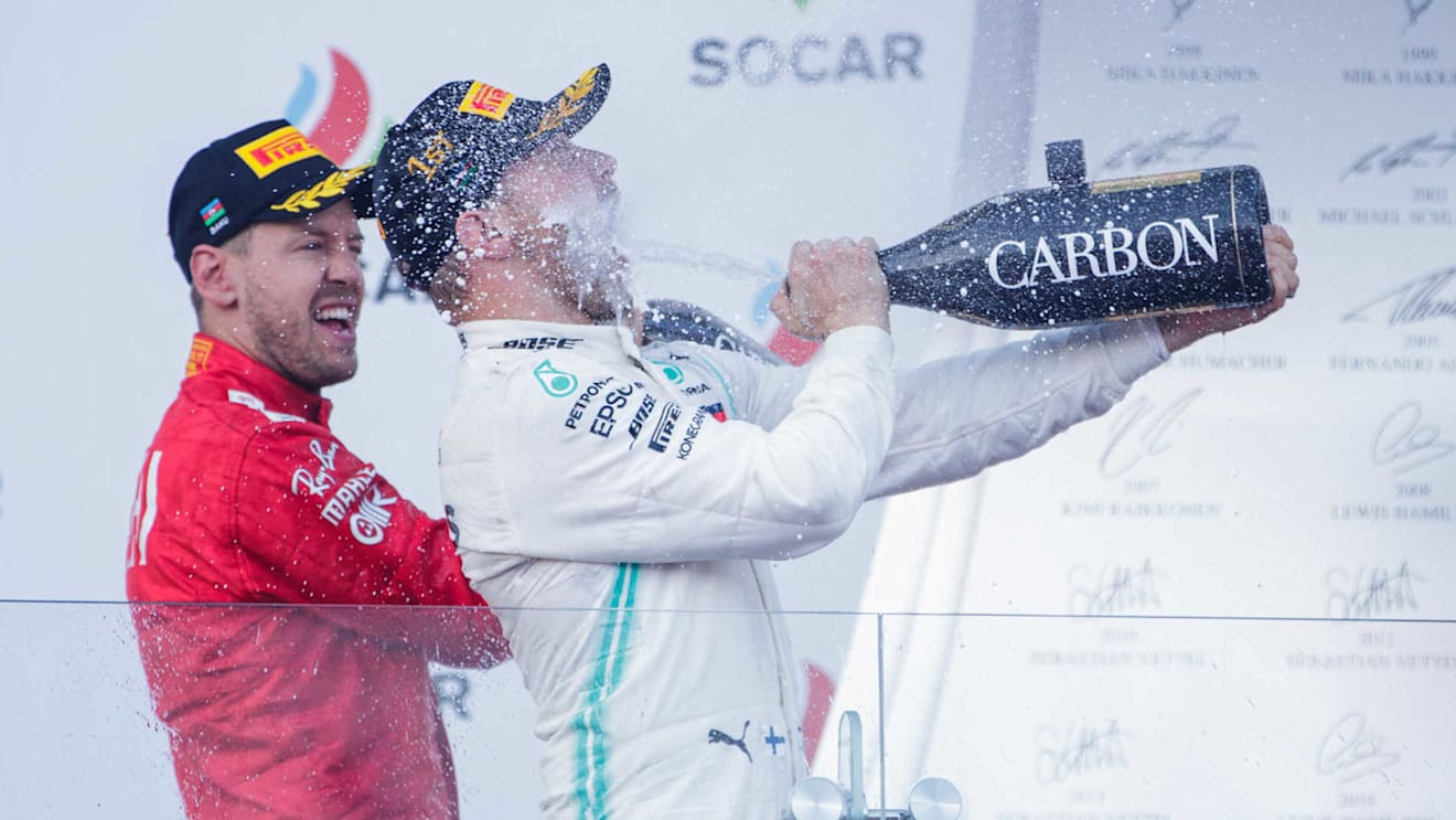 BAKU CITY CIRCUIT, AZERBAIJAN - APRIL 28: Valtteri Bottas, Mercedes AMG F1, 1st position, sprays the victory Champagne into his face during the Azerbaijan GP at Baku City Circuit on April 28, 2019 in Baku City Circuit, Azerbaijan. (Photo by Zak Mauger / LAT Images)