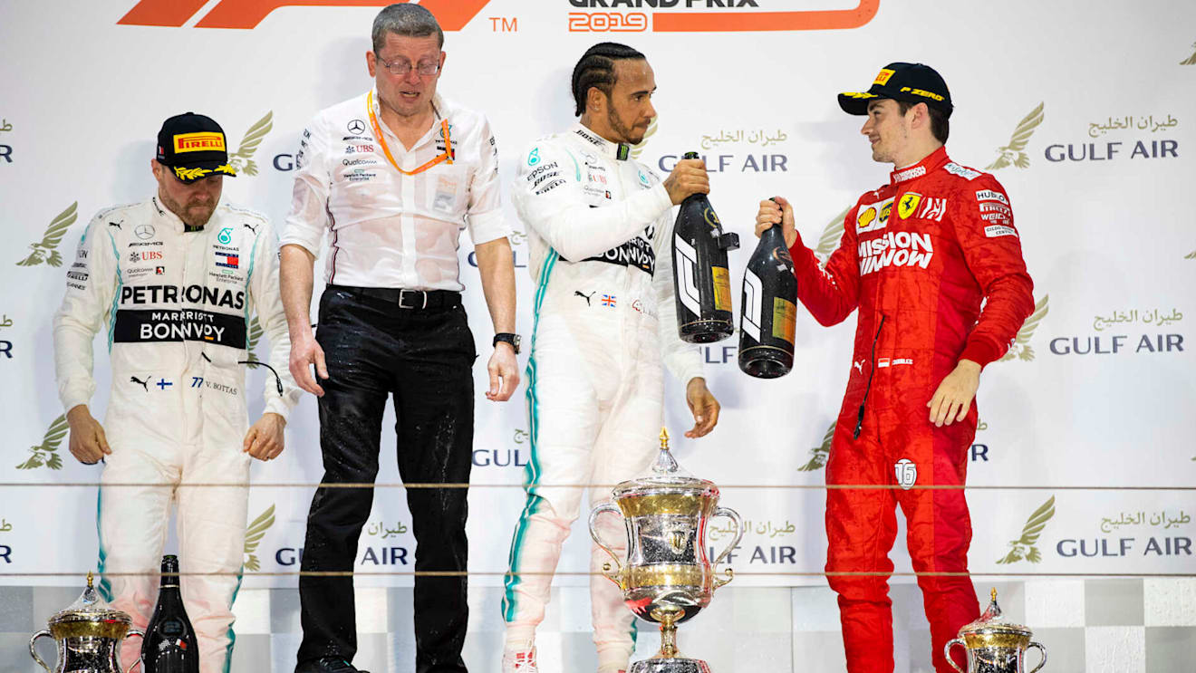 BAHRAIN INTERNATIONAL CIRCUIT, BAHRAIN - MARCH 31: Valtteri Bottas, Mercedes AMG F1, 2nd position, Andy Cowell, Managing Director, HPP, Mercedes AMG, Lewis Hamilton, Mercedes AMG F1, 1st position, and Charles Leclerc, Ferrari, 3rd position, on the podium during the Bahrain GP at Bahrain International Circuit on March 31, 2019 in Bahrain International Circuit, Bahrain. (Photo by Glenn Dunbar / LAT Images)