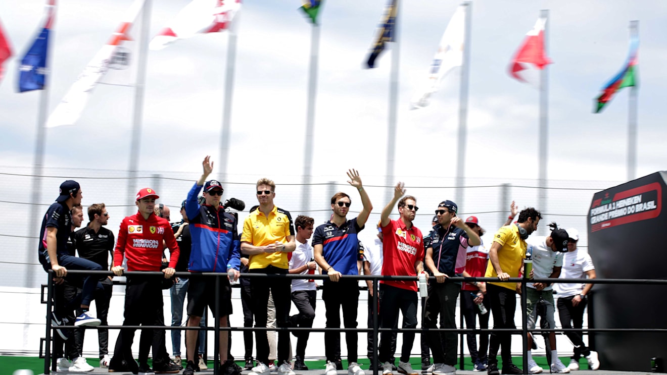 SAO PAULO, BRAZIL - NOVEMBER 17: Drivers including Daniil Kvyat of Russia and Scuderia Toro Rosso, Nico Hulkenberg of Germany and Renault Sport F1, Pierre Gasly of France driving the (10) Scuderia Toro Rosso STR14 Honda, Sebastian Vettel of Germany and Ferrari and Sergio Perez of Mexico and Racing Point are seen on the drivers parade before the F1 Grand Prix of Brazil at Autodromo Jose Carlos Pace on November 17, 2019 in Sao Paulo, Brazil. (Photo by Peter Fox/Getty Images)
