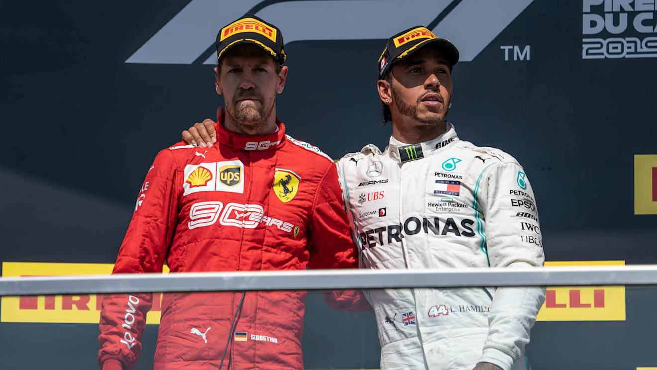 CIRCUIT GILLES-VILLENEUVE, CANADA - JUNE 09: Sebastian Vettel, Ferrari, 2nd position, and Lewis Hamilton, Mercedes AMG F1, 1st position, on the podium during the Canadian GP at Circuit Gilles-Villeneuve on June 09, 2019 in Circuit Gilles-Villeneuve, Canada. (Photo by Glenn Dunbar / LAT Images)