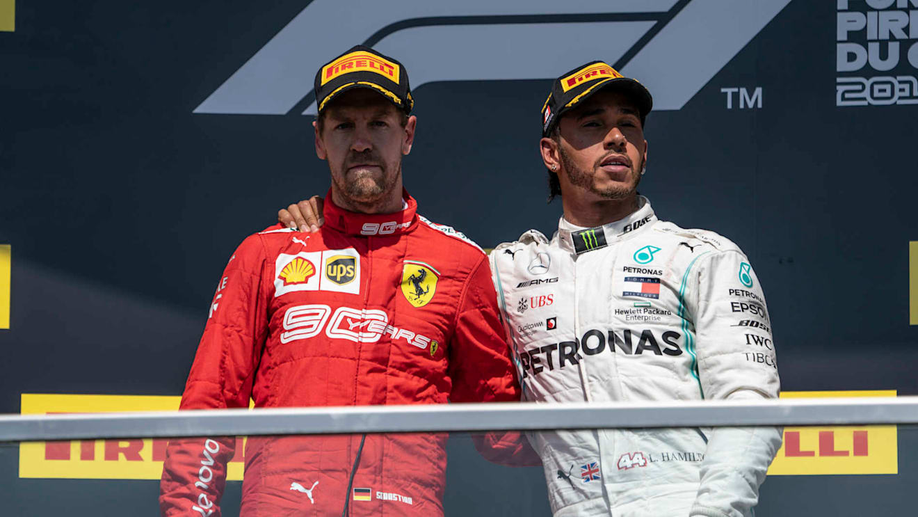 CIRCUIT GILLES-VILLENEUVE, CANADA - JUNE 09: Sebastian Vettel, Ferrari, 2nd position, and Lewis Hamilton, Mercedes AMG F1, 1st position, on the podium during the Canadian GP at Circuit Gilles-Villeneuve on June 09, 2019 in Circuit Gilles-Villeneuve, Canada. (Photo by Glenn Dunbar / LAT Images)