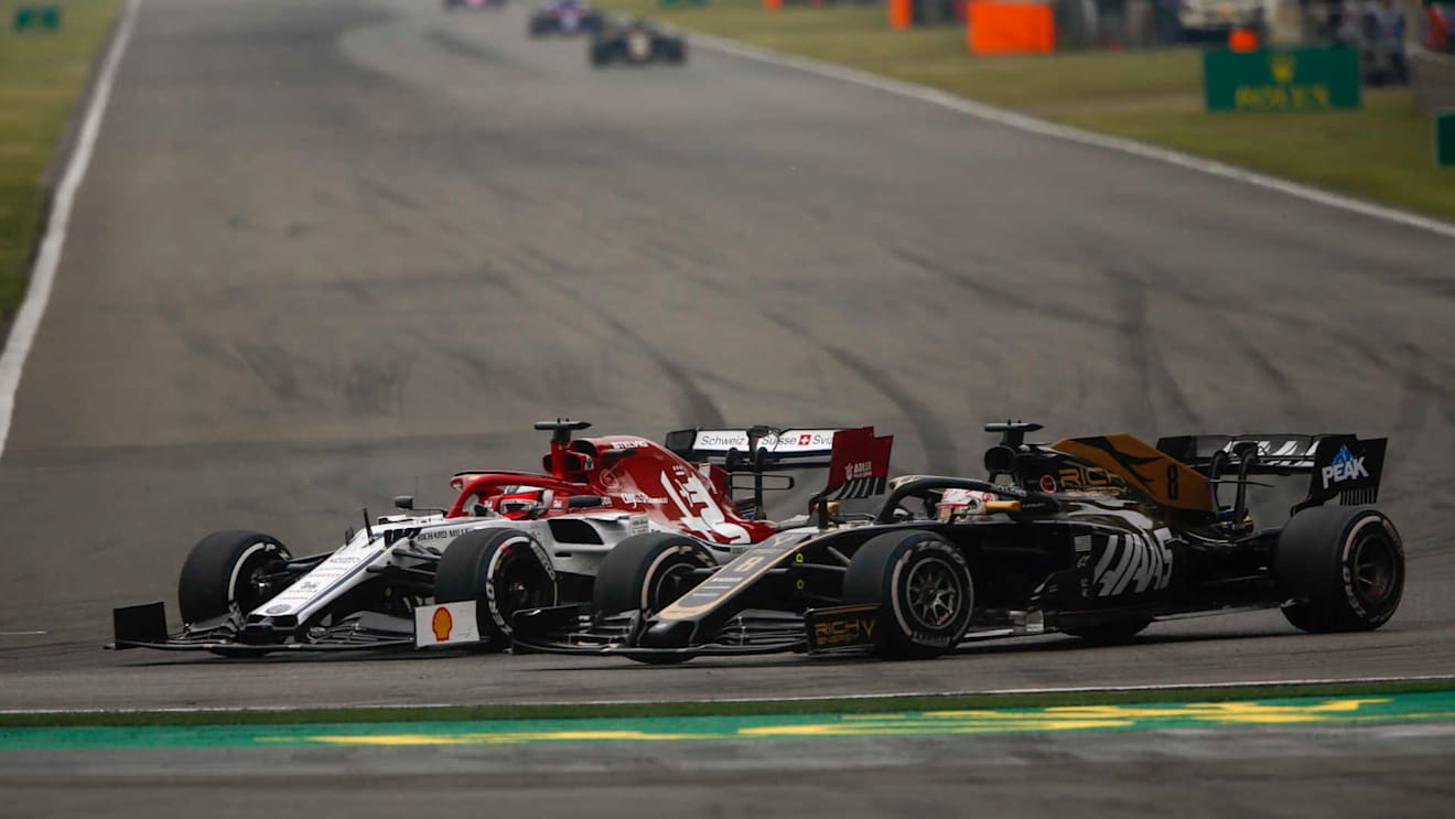 SHANGHAI INTERNATIONAL CIRCUIT, CHINA - APRIL 14: Kimi Raikkonen, Alfa Romeo Racing C38, battles with Romain Grosjean, Haas VF-19 during the Chinese GP at Shanghai International Circuit on April 14, 2019 in Shanghai International Circuit, China. (Photo by Andy Hone / LAT Images)