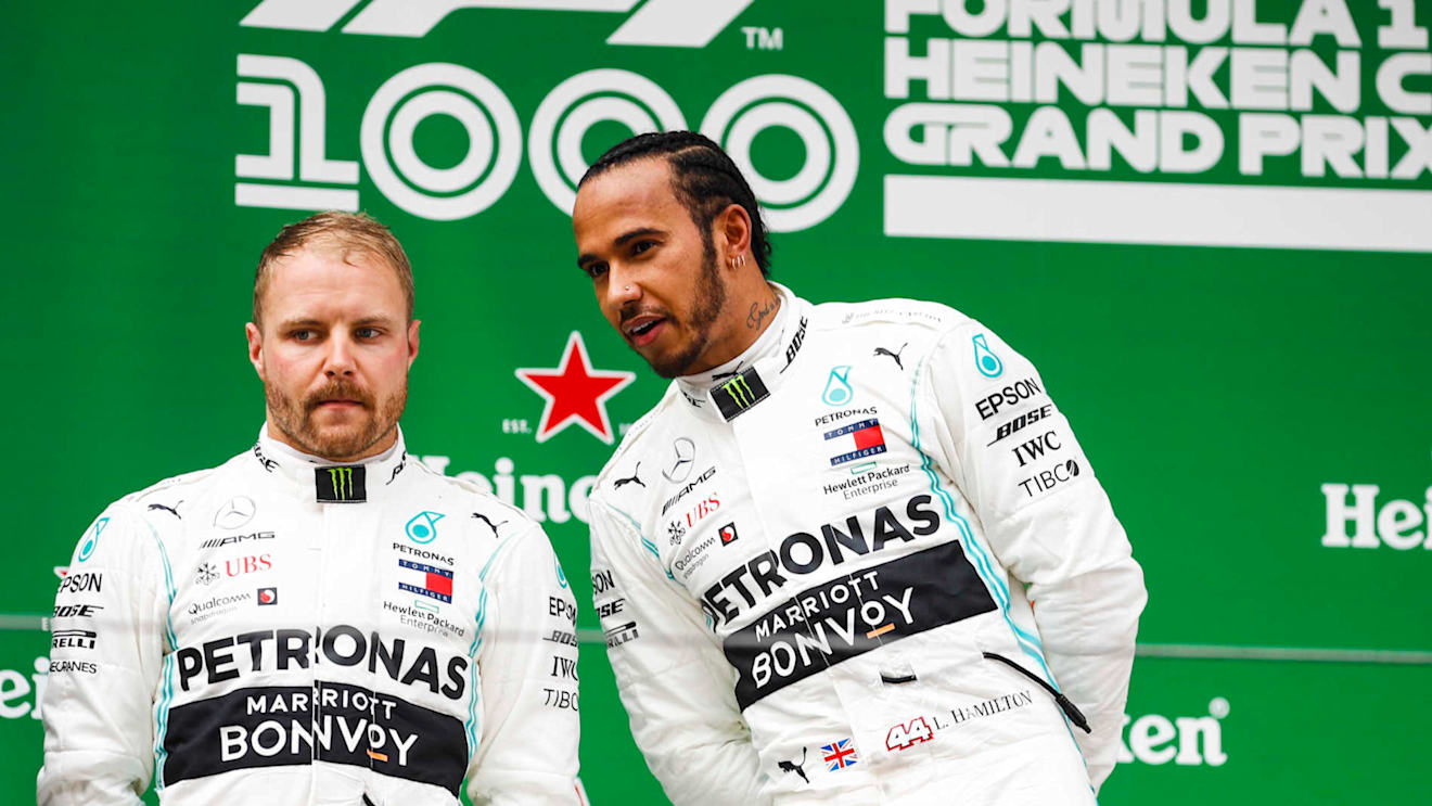 SHANGHAI INTERNATIONAL CIRCUIT, CHINA - APRIL 14: Valtteri Bottas, Mercedes AMG F1, 2nd position, and Lewis Hamilton, Mercedes AMG F1, 1st position, on the podium during the Chinese GP at Shanghai International Circuit on April 14, 2019 in Shanghai International Circuit, China. (Photo by Glenn Dunbar / LAT Images)