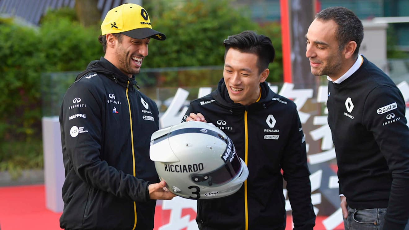 SHANGHAI INTERNATIONAL CIRCUIT, CHINA - APRIL 11: Daniel Ricciardo, Renault F1 Team, shows his helmet to Cyril Abiteboul, Managing Director, Renault F1 Team and Guanyu Zhou during the Chinese GP at Shanghai International Circuit on April 11, 2019 in Shanghai International Circuit, China. (Photo by Jerry Andre / Sutton Images)