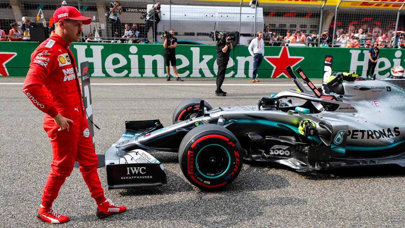 SHANGHAI INTERNATIONAL CIRCUIT, CHINA - APRIL 13: Sebastian Vettel, Ferrari, and pole man Valtteri Bottas, Mercedes AMG W10, on the grid after Qualifying during the Chinese GP at Shanghai International Circuit on April 13, 2019 in Shanghai International Circuit, China. (Photo by Steven Tee / LAT Images)