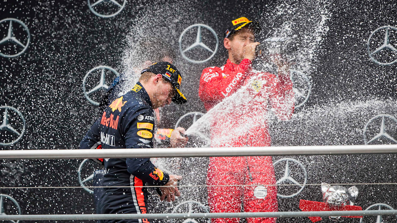 HOCKENHEIMRING, GERMANY - JULY 28: Race winner Max Verstappen, Red Bull Racing and Sebastian Vettel, Ferrari celebrates on the podium with the champagne during the German GP at Hockenheimring on July 28, 2019 in Hockenheimring, Germany. (Photo by Sam Bloxham / LAT Images)
