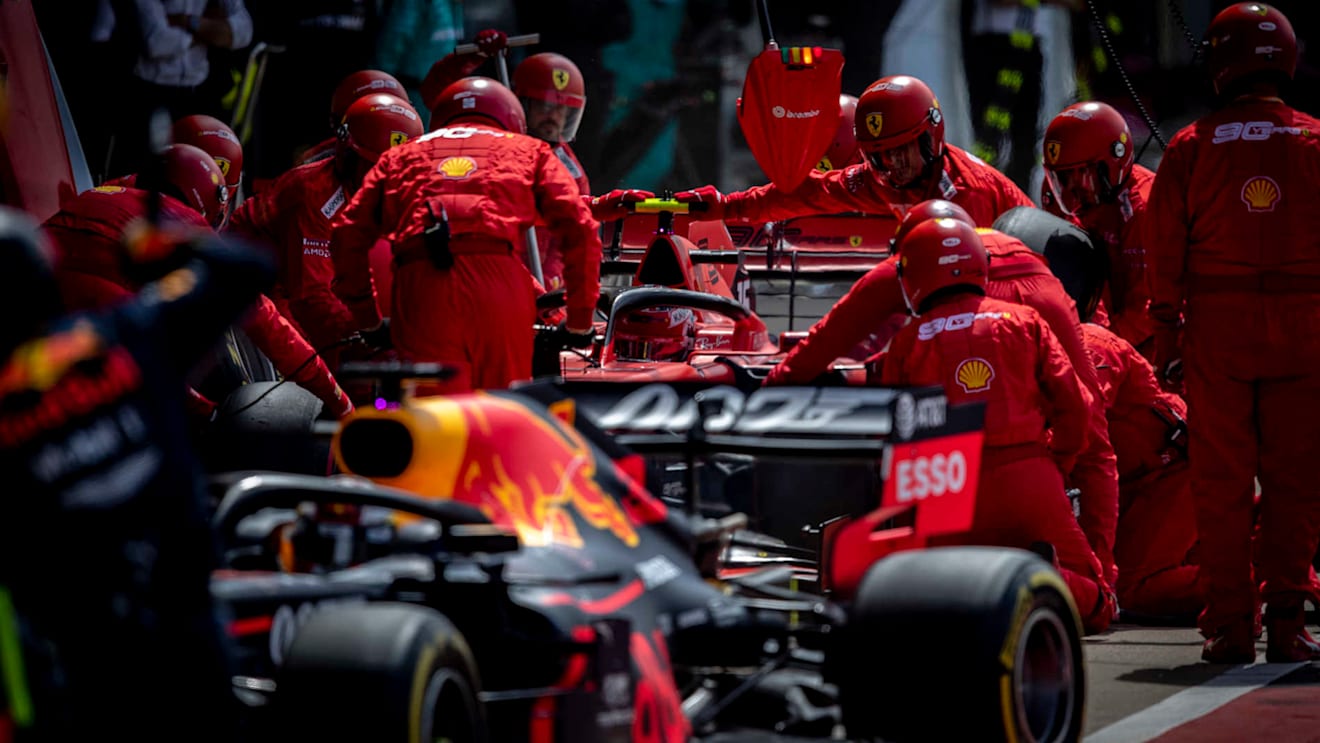 SILVERSTONE, UNITED KINGDOM - JULY 14: Charles Leclerc, Ferrari SF90, pit stops behind Max Verstappen, Red Bull Racing RB15 during the British GP at Silverstone on July 14, 2019 in Silverstone, United Kingdom. (Photo by Glenn Dunbar / LAT Images)